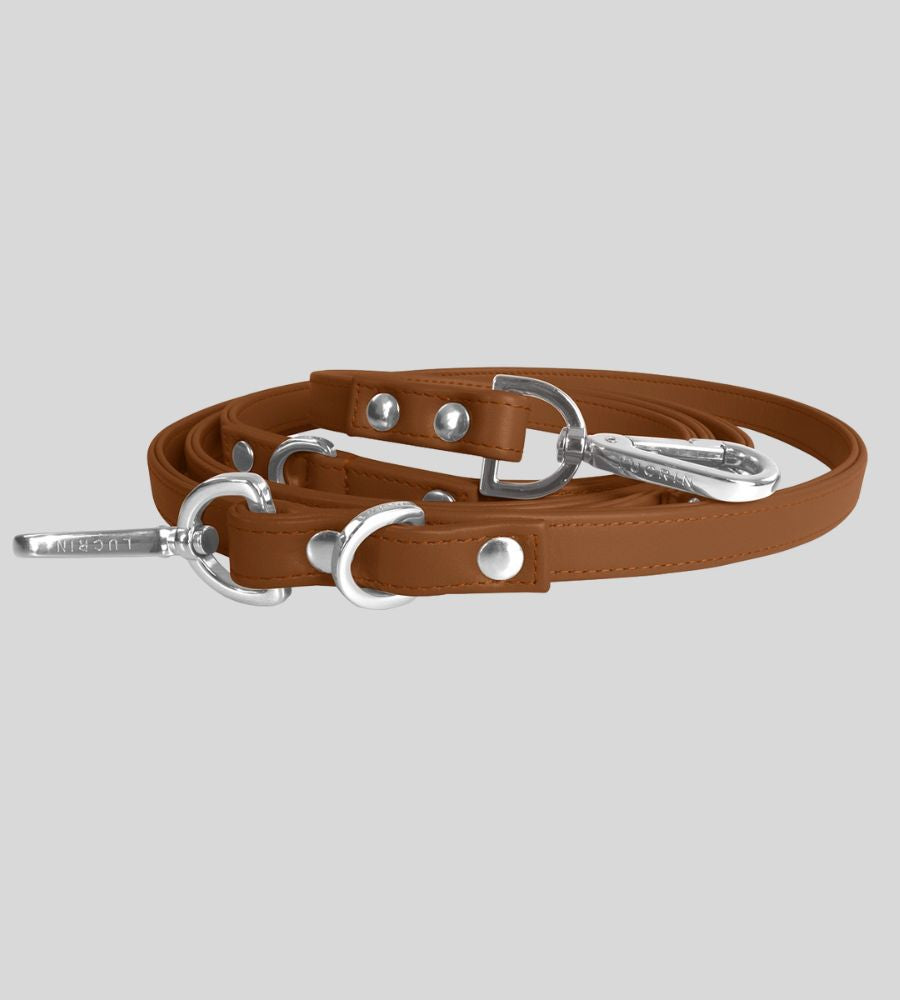 Coiled tan leather dog leash with silver hardware