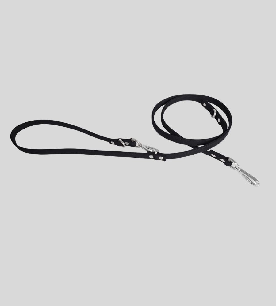 Coiled black leather dog leash with silver snap hook and O-rings