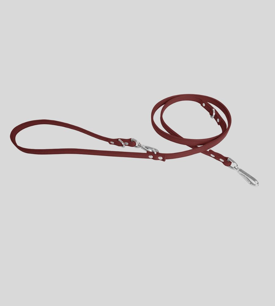 Coiled burgundy leather dog leash with rivets