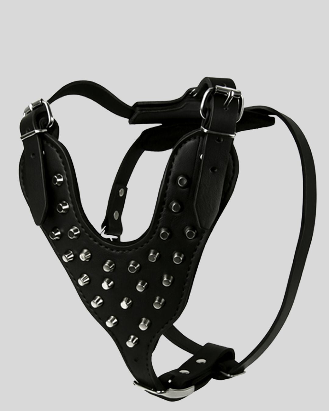 studio display of black leather dog harness with silver studs and adjustable buckles