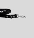 Close-up silver clasp detail on premium black leather dog leash