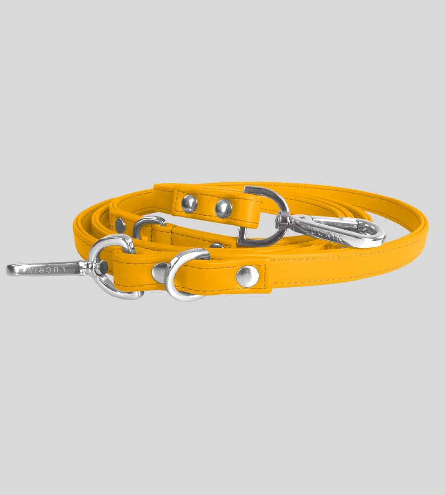 Coiled yellow leather dog leash with silver hardware and rivets